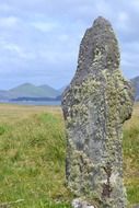 prehistoric celtic stone sculpture on beautiful landscape, ireland