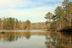 a large pond next to a small cottage