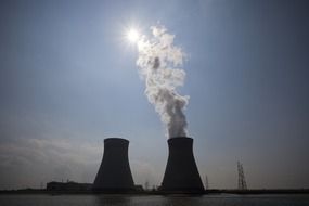 silhouette of a nuclear power plant on the blue sky