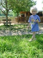 barefoot child girl on farm