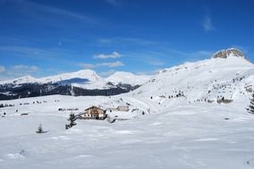 wooden hut in snowy mountains