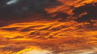 red dramatic sunset sky with fluffy clouds