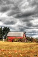 red barn under storm clouds