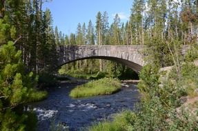 stone bridge over a stream among beautiful nature