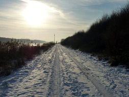 car tracks on a snowy road