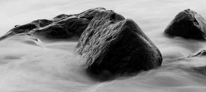 Black and white photo of stones in the water
