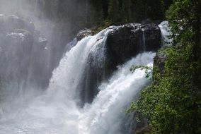 waterfall in the mountains of norway on a sunny day