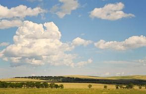 tranquil countryside beneath high clouds at blue sky