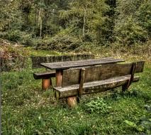 rest area, wooden table and benches at forest