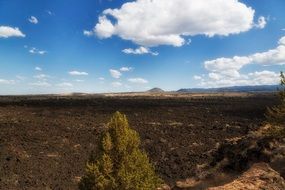 lava beds and fluffy clouds california landscape