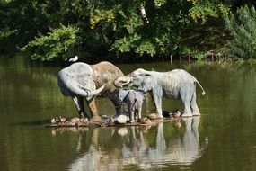 landscape of Sculpture of elephants on the water in the forest