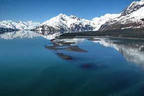 lake at the foot of an alpine mountain in the snow