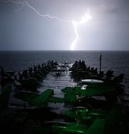 landscape of lightning in the sky and the airport by the water