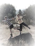 boys standing on the rock