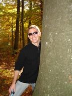 Man near the tree in autumn