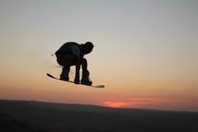 snowboarder silhouette in the sand desert