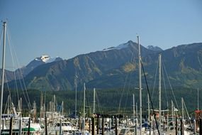 landscape of harbor with ships near the mountains