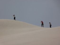 three people in the sand dunes in Argentina