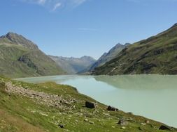 green mountains at blue sky mirroring on calm water, germany