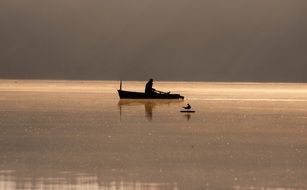 landscape of man in boat on lake