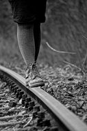 boy waking on the railway