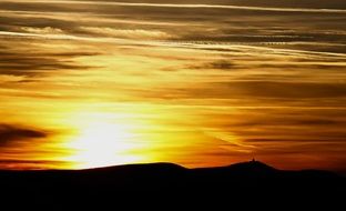 Bright orange sun behind the mountains