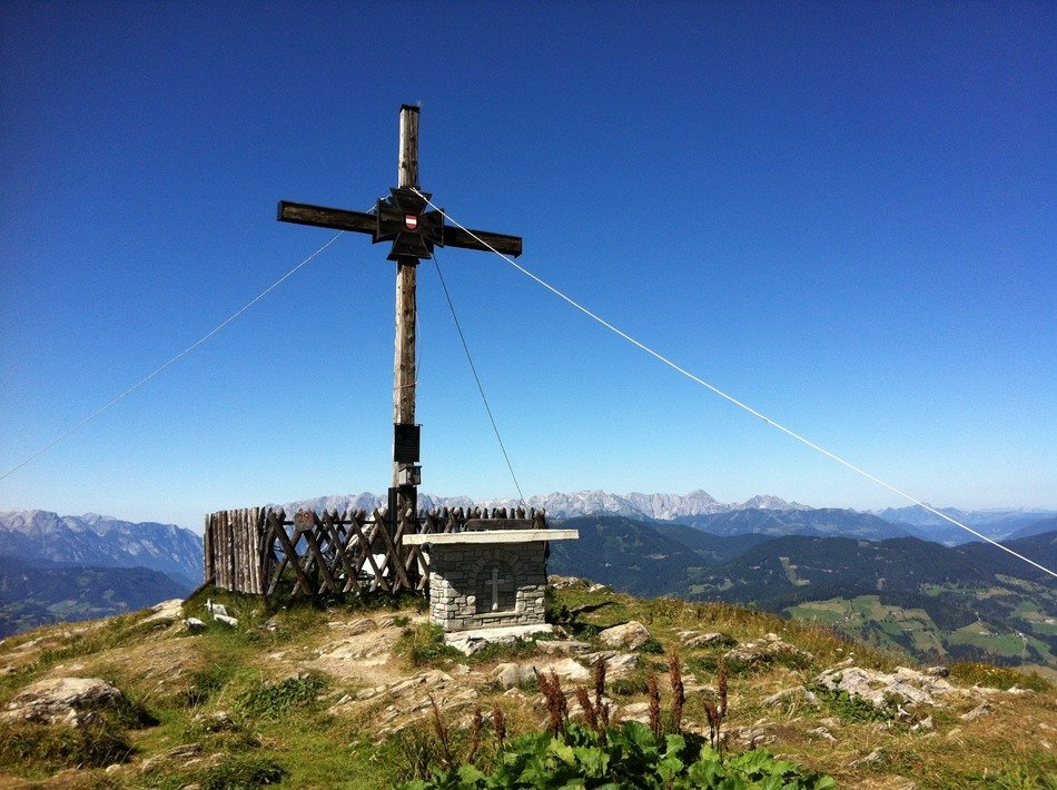 aged cross on mountain summit at scenic landscape, austria, Sankt Johann am Tauern