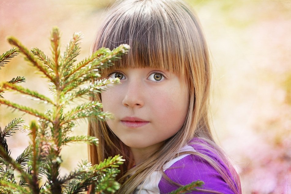 photo of the girl near the Christmas tree