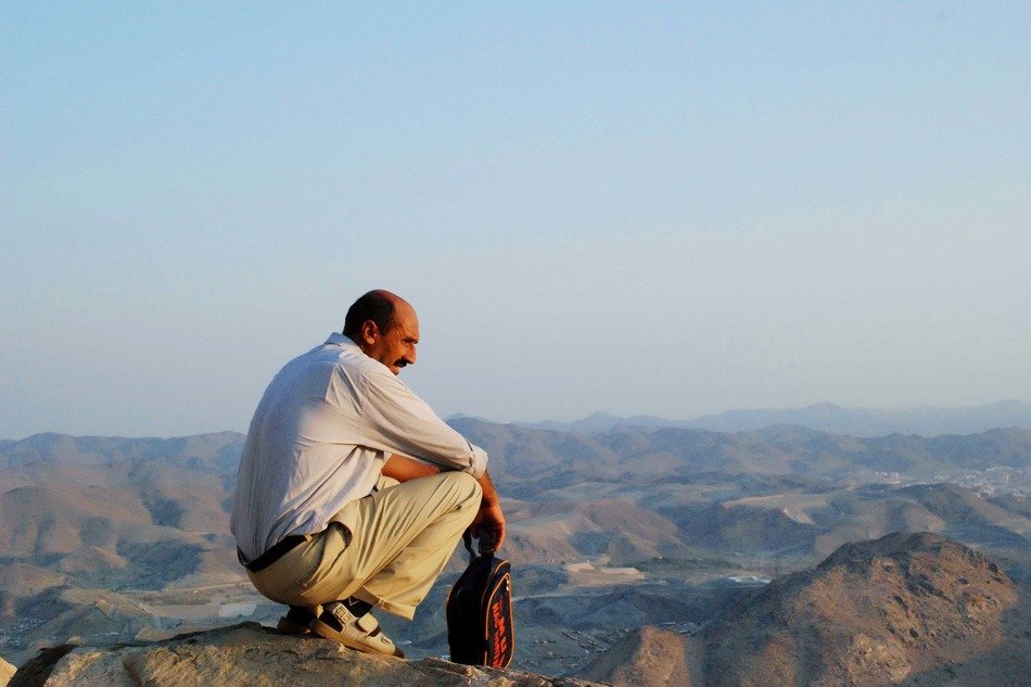 Arabic man sitting on the mountain
