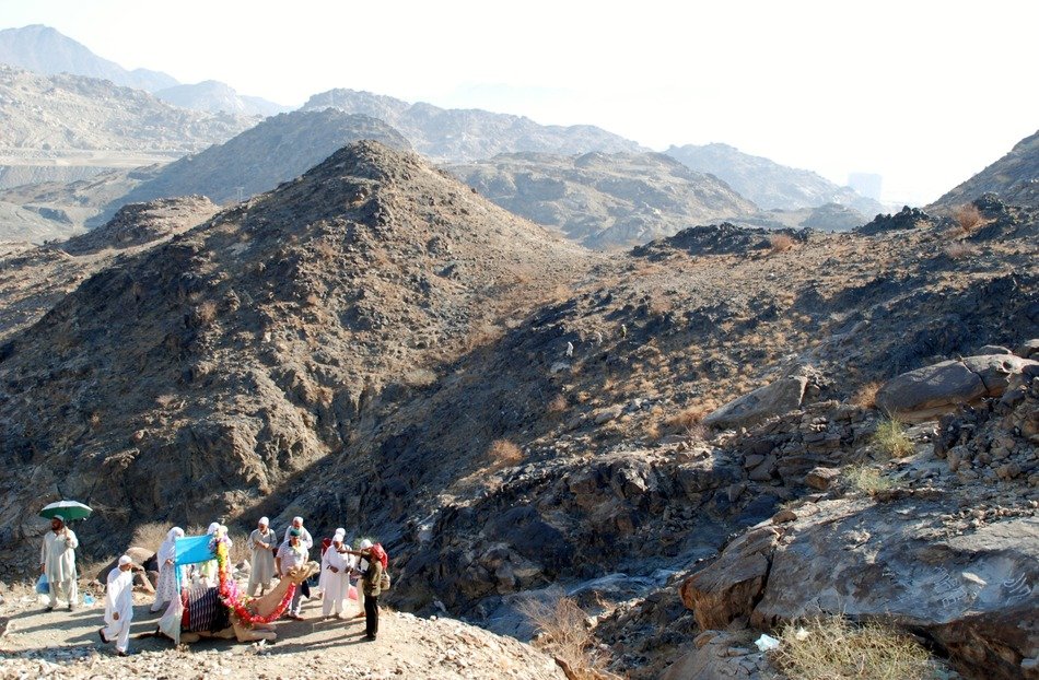 people and a camel in the mountains
