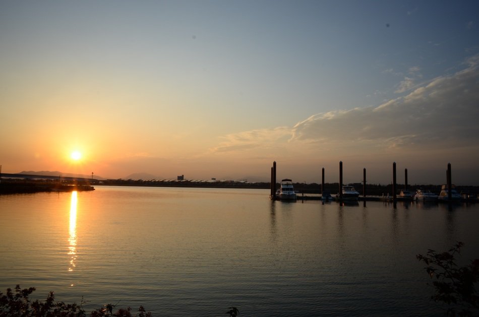 Sunny sunset over the lake with yachts