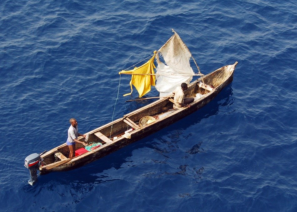 gulf of guinea with fishermen boat floating on a sunny day