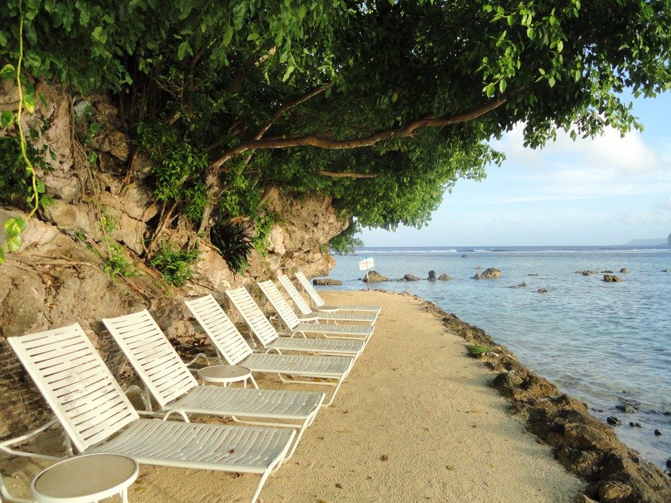wooden loungers on the beach near the ocean