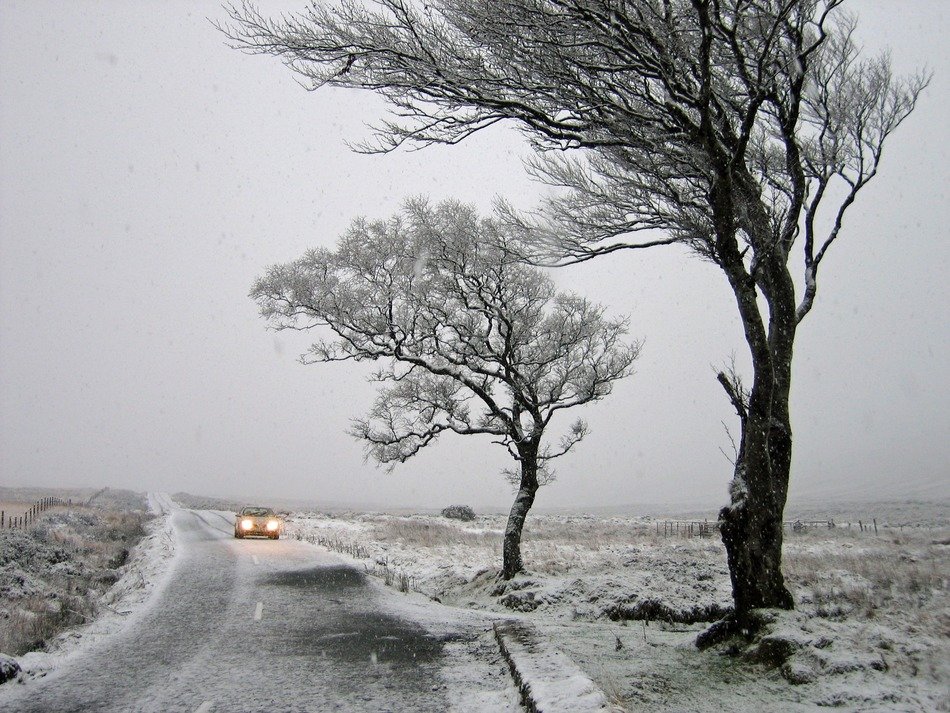car on the winter road in ireland