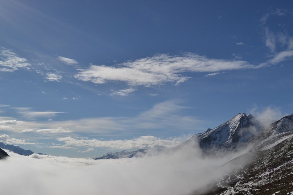 snowy mountains in the clouds on a clear day