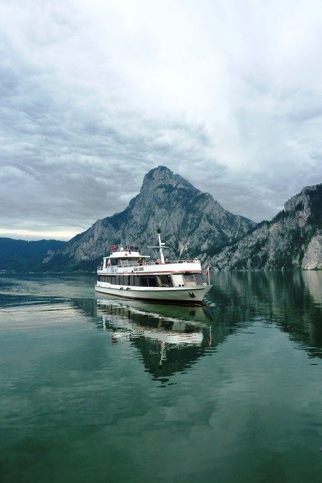 cruise liner floats along the mountains