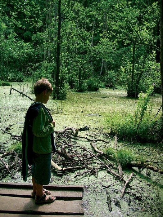 boy in a green suit in the park