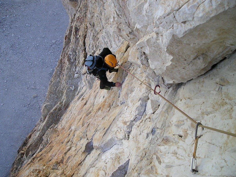lone climber in the cliffs of italy