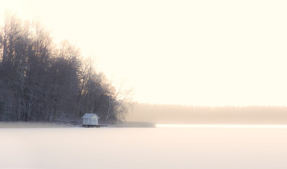Small cottage near the forest in frosty weather