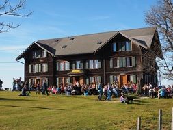 lot of people near the hotel in the mountains of switzerland