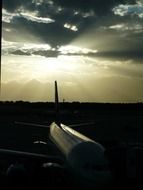 sunset over the silhouette of an airplane