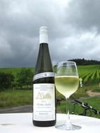 white wine on a table among vineyards