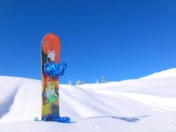 snowboard in the snow against the backdrop of snow-covered mountain landscape