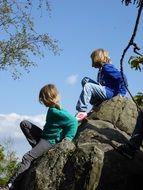 children on a big stone