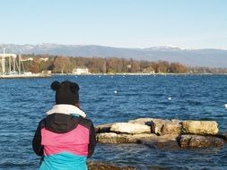 teenager girl at pond, back view