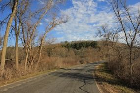 tranquil road landscape with white clouds