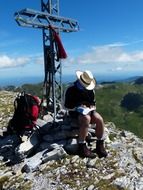 iron cross on top of a mountain