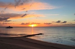 sunrise on an orange sky over the sea horizon