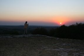 man in the mountains at sunset