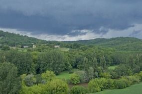 picturesque green valley on the background of the cloudy stormy sky